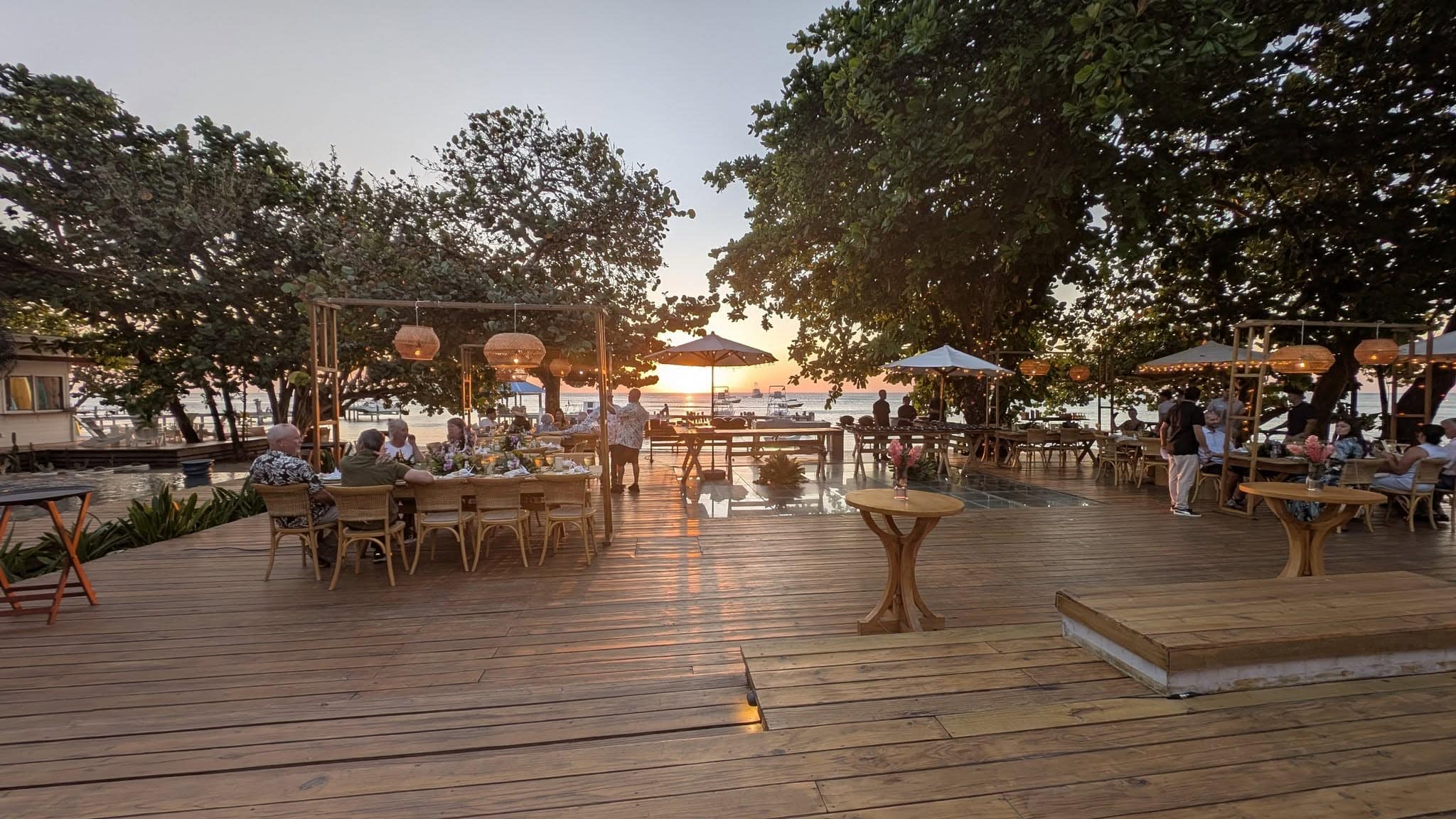 Elegant outdoor restaurant with sunset views and tropical ambiance.