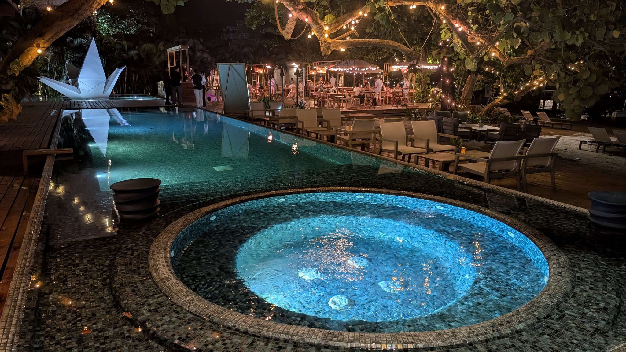 Elegant pool area at Luna Muna by Ibagari with ambient lighting and cozy seating.