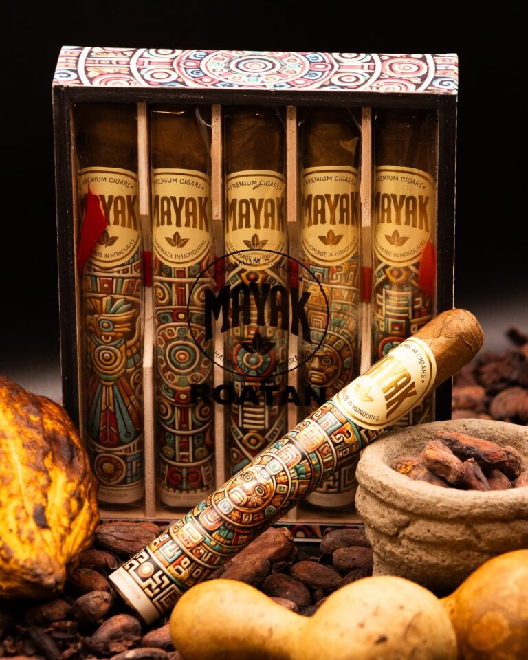 Colorful Mayak cigars from Honduras in a decorative wooden box displayed among rocks on Roatan, Bay Islands.