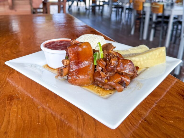 Delicious mutton dish with peppers, served with side sauces and fresh vegetables.