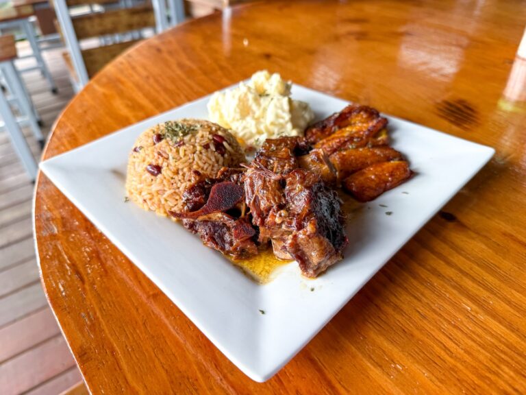 Mutton Pepper Caribbean Grill: flavorful Caribbean-style mutton served with rice, plantains, and mas.