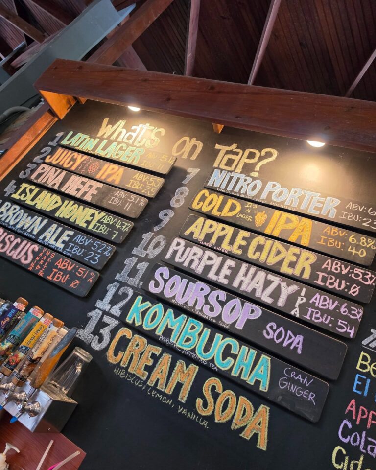 Colorful beer menu board at Roatan Island Brewing during Easter Egg Hunt event.