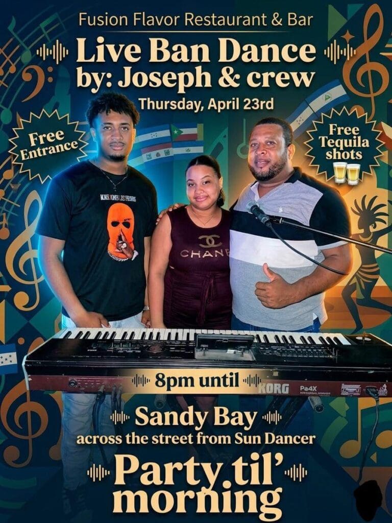 Three performers, including a male musician with a keyboard, pose at a live music event in Roatan, Honduras, with a colorful background featuring musical notes and tropical motifs.