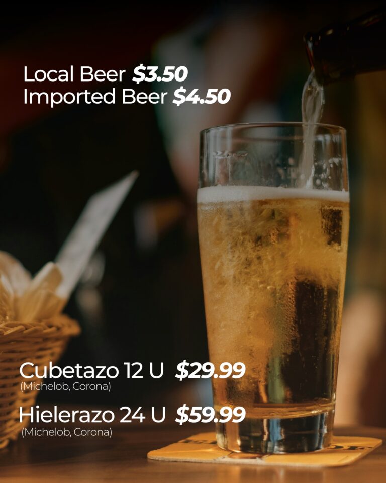 A glass of beer being poured with a blurred background featuring a menu listing prices for local and imported beers at a business located in Roatan, Honduras.