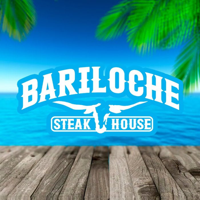 The image shows a sign for Bariloche Steak House set against a tropical background with palm leaves, a blue ocean, and a wooden deck, indicating a dining establishment in Roatan, Honduras.