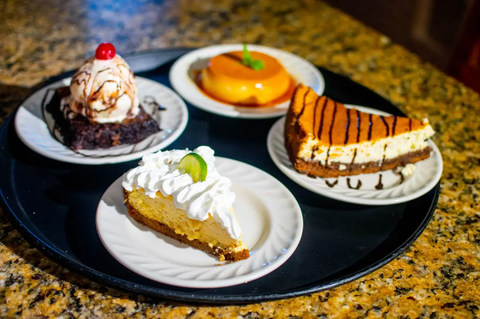 Homemade desserts at Herby’s Sports Bar & Grill including key lime pie, cheesecake, flan, and a brownie with ice cream