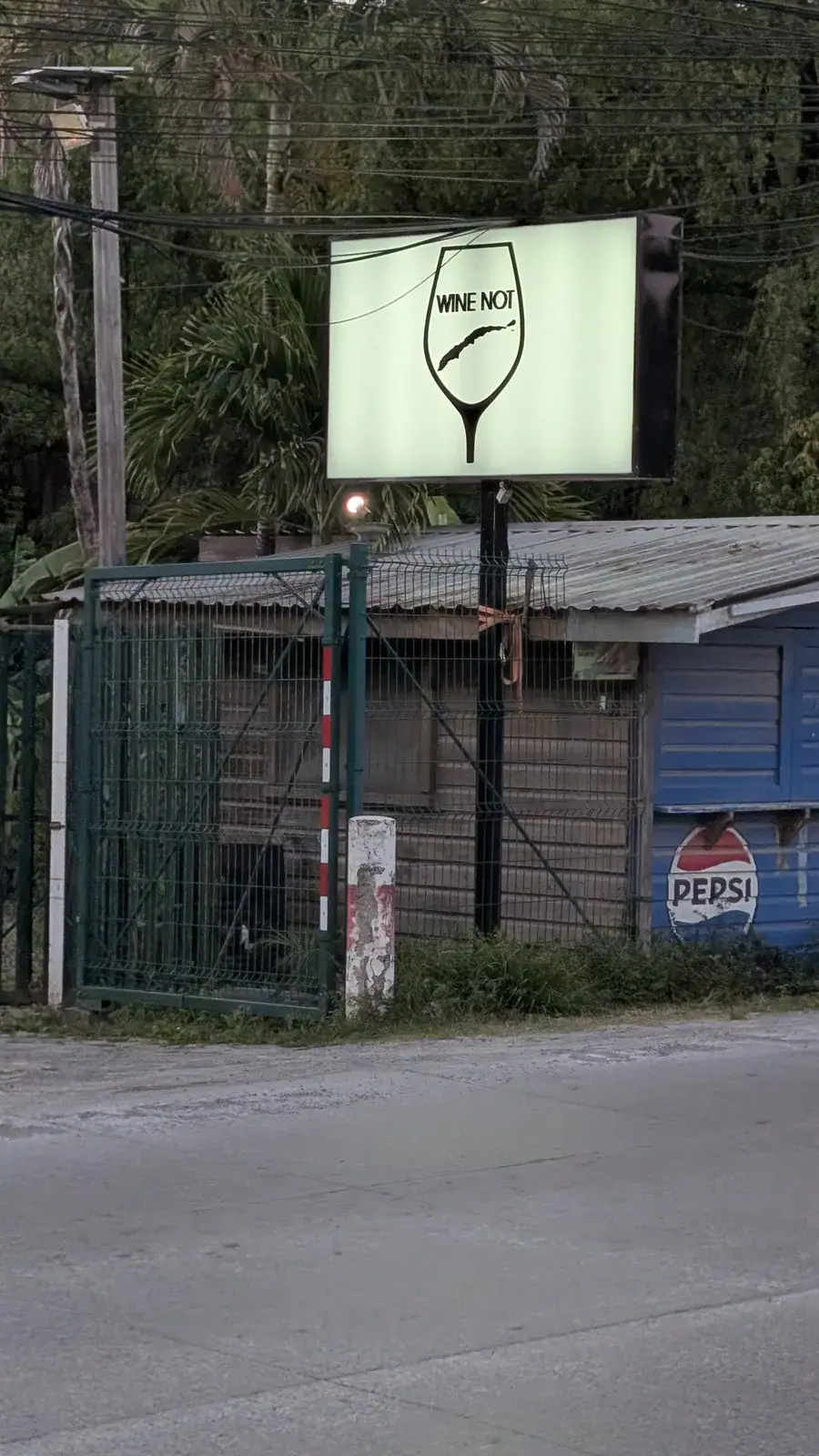 Wine Not backlit entrance sign on main road in French Harbour Roatan