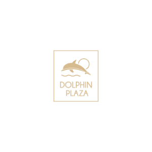 A sign displaying the logo of Dolphin Plaza with a stylized dolphin illustration, located in Roatan, Honduras.