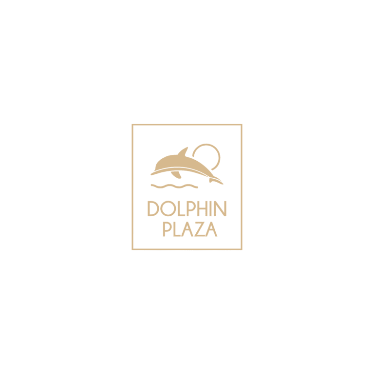 A sign displaying the logo of Dolphin Plaza with a stylized dolphin illustration, located in Roatan, Honduras.