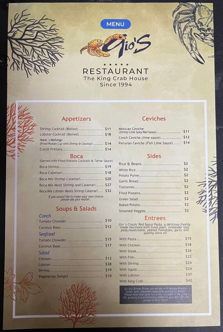 A menu from Gio's restaurant in Roatan, Honduras, features seafood dishes such as shrimp cocktail, lobster, conch ceviche, and various side options, with decorative coral illustrations surrounding the text.