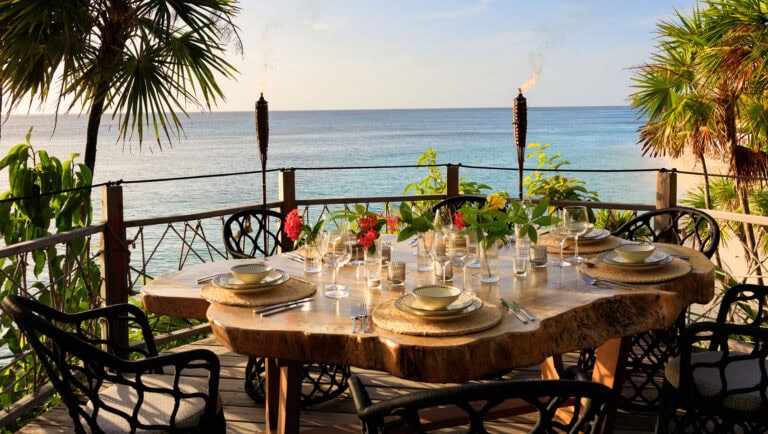 Green Flash Table oceanfront table set at sunset over the Caribbean