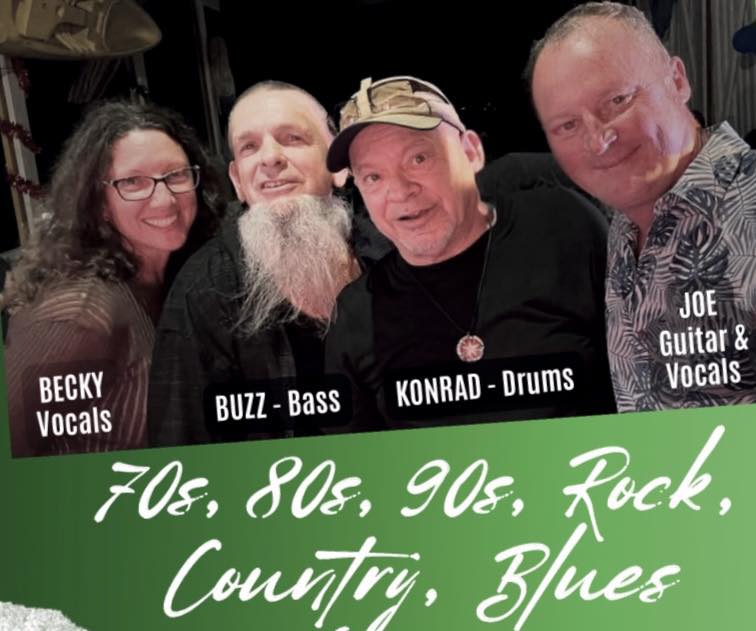 A group of four musicians including Becky on vocals, Buzz on bass, Konrad on drums, and Joe on guitar and vocals posing together at a music event in Roatan, Honduras, with a green banner promoting 70s, 80s, and 90s rock, country, and blues music.