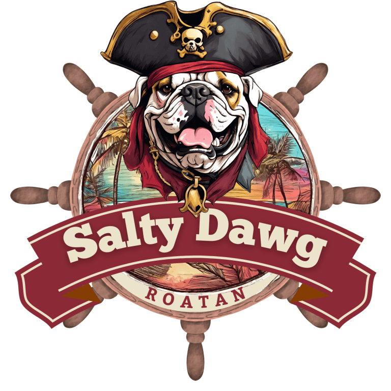 A cartoon bulldog dressed as a pirate with a skull and crossbones hat, red bandana, and gold accessories, positioned in front of a colorful sunset and palm trees background inside a ship's wheel with the text "Salty Dawg" and "Roatan, Honduras.