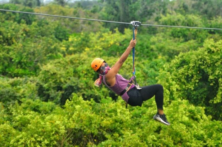 Ziplining over lush green forests in Roatan, Honduras. Experience thrilling views and outdoor fun wi.