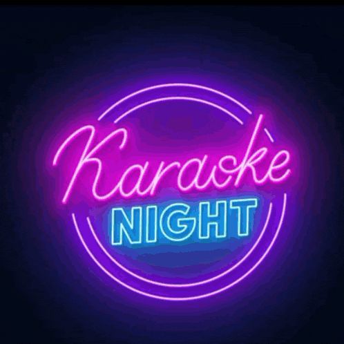 Neon sign displaying 'Karaoke Night' in vibrant purple and blue colors, set against a dark background, promoting entertainment events in Roatan, Honduras.