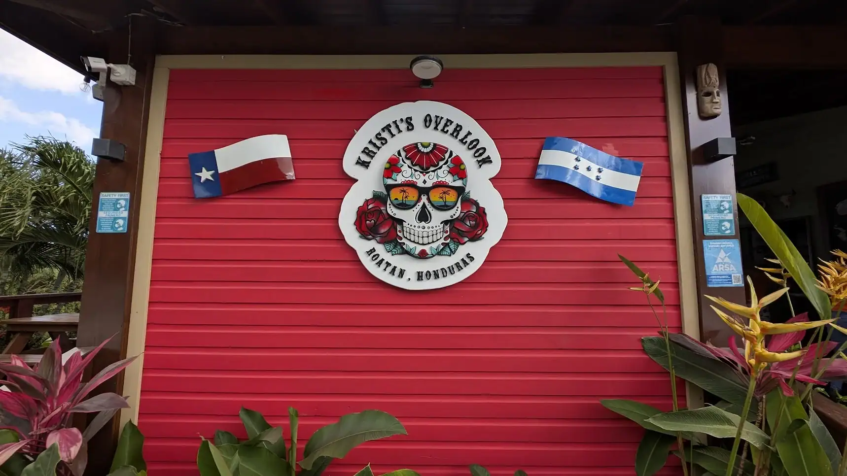 Kristi’s Overlook wall sign with Honduras and Texas flags