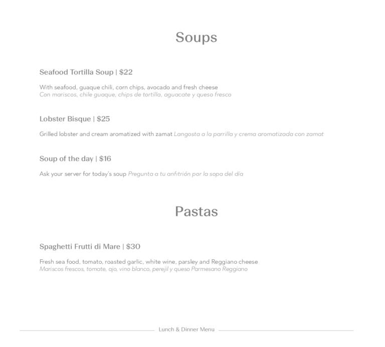 A close-up view of a menu on Roatan, Honduras, featuring various soup and pasta dishes with clear dish descriptions and prices.