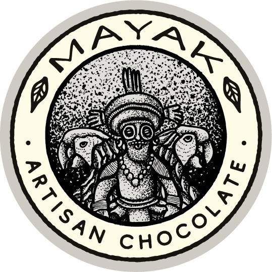 Mayak Artisan Chocolate logo featuring an indigenous Mayan figure wearing traditional attire and a headpiece, surrounded by two fish, with the text 'MAYAK ARTISAN CHOCOLATE' encircling the design in black and white.