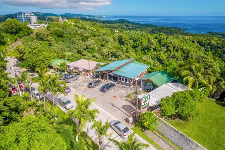 Mutton Pepper Caribbean Grill restaurant on Roatan with lush green surroundings.
