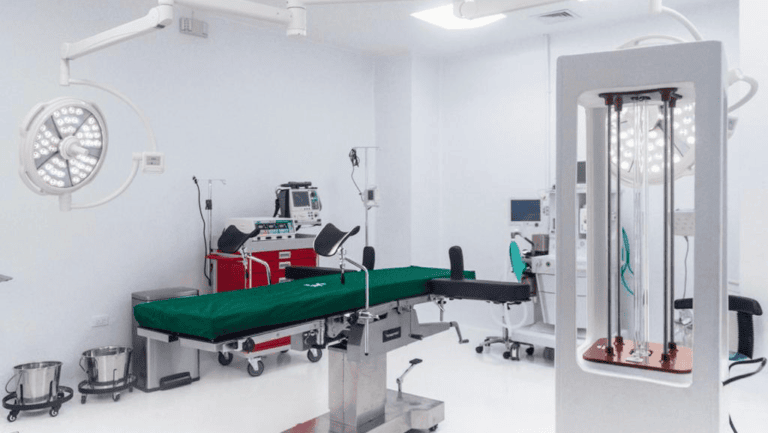 Modern operating room in Roatan, Honduras equipped with surgical lights, anesthesia machine, and patient bed.