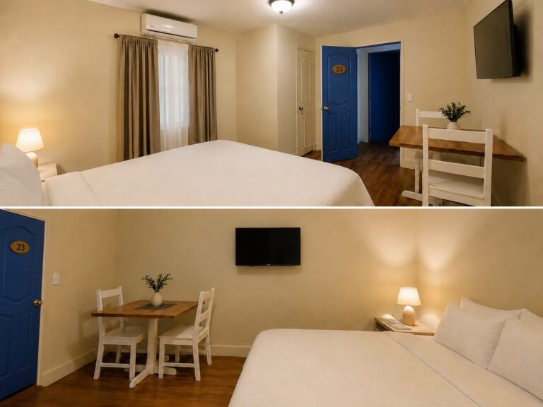 Bright guest room in Roatan, Honduras, furnished with a bed, blue entry door, dining table, television, and window air conditioner.