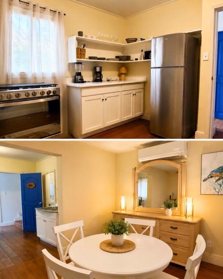 Bright furnished kitchen and dining area with stainless steel appliances, white cabinetry, round table, and coastal decor in a Roatan, Honduras home.