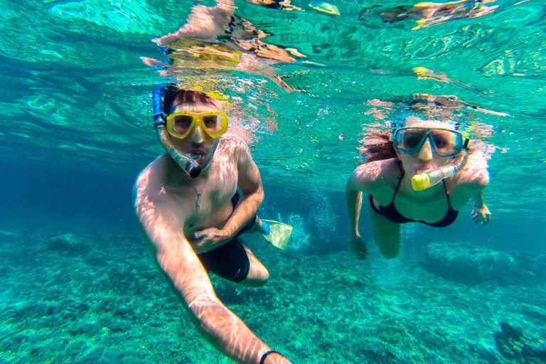 People snorkeling during Roatan fire tours.