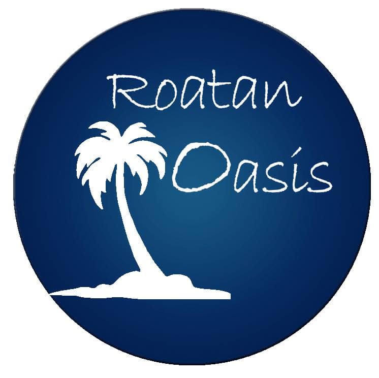 The image shows a circular logo for Roatan Oasis in Honduras, featuring a white silhouette of a palm tree on a small island set against a dark blue background with the words "Roatan Oasis" written in a casual, handwritten style.