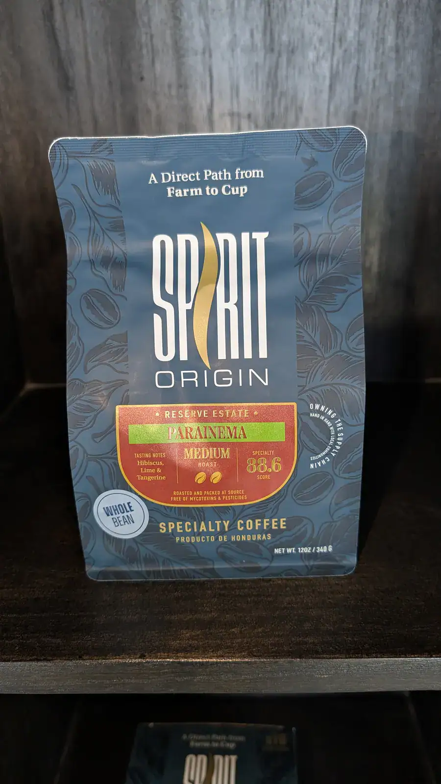 Blue packaging of Spiirit Origin coffee from Honduras featuring the Parainema high-yield coffee variety and a Whole Bean label.