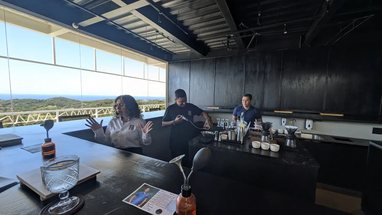 The Spirit Origin Coffee Omakase team — Kathya Irias with her baristas and bartenders in matching Spirit Origin uniforms, Roatan