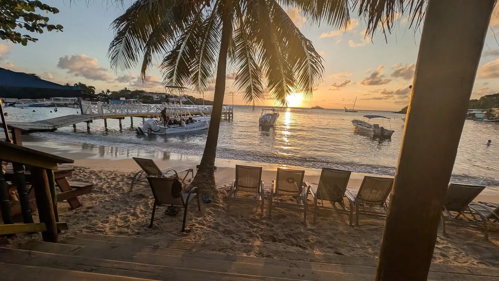 Beach chairs and sunset view from Sundowners on Half Moon Bay West End Roatan