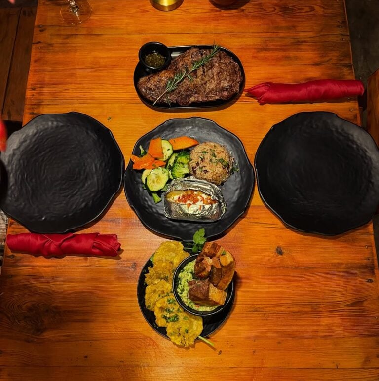 Delicious grilled steak served with fresh vegetables and flavorful sides at The Estancia Steak House.