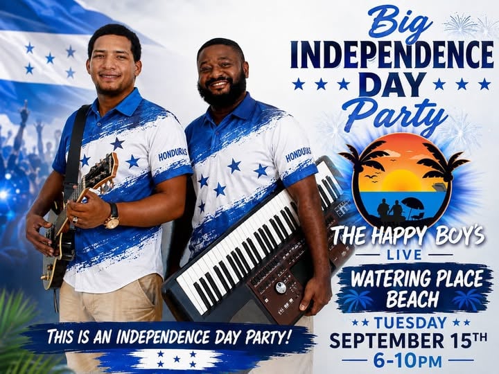 Two musicians from Roatan, Honduras, perform at an Independence Day celebration on a beach with a sunset, palm trees, and ocean in the background.