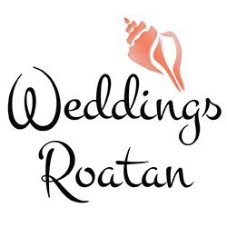 Elegant wedding venue featuring a decorated aisle and seating on a lush green lawn overlooking the turquoise waters of Roatan, Honduras.